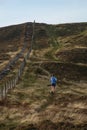A woman is running among the Scottish hills in the park Royalty Free Stock Photo