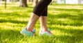 Woman in running shoes stepping on grass Royalty Free Stock Photo