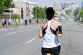 Woman running with smartphone attached to shoulder