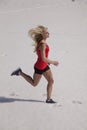 Woman running in the snow in shorts Royalty Free Stock Photo