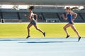 Woman, running and stadium track of athletes in competition, fitness or athletics in the outdoors. Fit, active or sporty Royalty Free Stock Photo