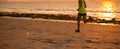 woman running at sunset sandy beach