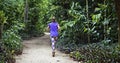 Woman running on trail at `Bosque da Freguesia`, Freguesia Forest Public Park, Rio Royalty Free Stock Photo