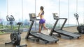 Woman running on treadmill. Exercise bikes and treadmills in sports center. 3D illustration