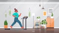 Woman running on treadmill at home girl having workout cardio fitness training healthy lifestyle home sport