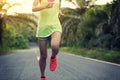 Woman running on tropical forest trail Royalty Free Stock Photo