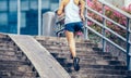 woman running up city stairs