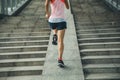 Woman running up city stairs