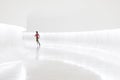 Woman running in a white hallway