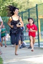 Woman running beside a young boy.