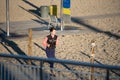 Woman runs along the Barcelona promenade in time of Covid 19 in winter 2021