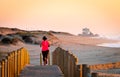 Woman Runs on Boardwalk