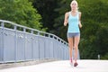 Woman runs outdoor on a bridge as stamina training