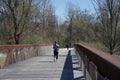 A Woman runs over the Wolf River Bridge