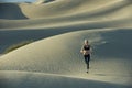 Woman runs on sand dunes Royalty Free Stock Photo