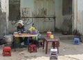 Woman runs simple street kitchen and fast food restaurant.