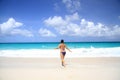 Woman runs towards the sea Royalty Free Stock Photo