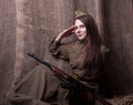 Woman in Russian military uniform with rifle. Female soldier during the second world war. Royalty Free Stock Photo
