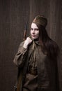 Woman in Russian military uniform with rifle. Female soldier during the second world war. Royalty Free Stock Photo