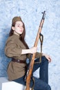 Woman in Russian military uniform with rifle. Female soldier during the second world war. Royalty Free Stock Photo