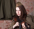 Woman in Russian military uniform shoots a rifle. Female soldier during the second world war. Royalty Free Stock Photo