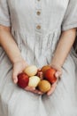 Woman in rustic linen dress holding natural dyed easter eggs in hands. Happy Easter. Aesthetic Royalty Free Stock Photo