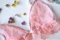 Woman`s accessories on the wooden desk. Beautiful lace lingerie, armlets, flowers and nail polish. Royalty Free Stock Photo