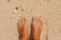 Woman's bare feet on the beach. Royalty Free Stock Photo