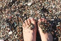 Woman`s Bare Feet on the beach. Sand texture . Royalty Free Stock Photo