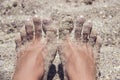 Woman`s bare feet covered with sand on the beach. Royalty Free Stock Photo