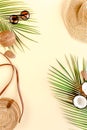 Woman`s beach accessories: bikini, rattan bag, straw hat, tropical palm leaves on yellow background. Summer background. Royalty Free Stock Photo