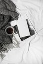 Woman`s bed top view on a lazy sunday morning in cold weather . Lifestyle with book, coffee and warm clothes. Royalty Free Stock Photo
