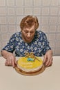 woman in the 90s, blowing candles at her birthday party in an old and rustic setting Royalty Free Stock Photo