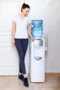 Woman, 20s, caucasian, standing at water cooler wearing sportwear