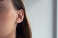 Woman`s ear close-up. Pearl earring, natural blonde woman touching her face Royalty Free Stock Photo