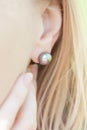 Woman's ear with a dark pearl earring Royalty Free Stock Photo