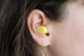 Woman`s ear with an ear plug, noice reduce, noice pollution Royalty Free Stock Photo