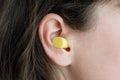 Woman`s ear with an ear plug, noice reduce, noice pollution Royalty Free Stock Photo