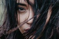 Woman`s eyes are shown close-up under hair fluttering in the wind Royalty Free Stock Photo