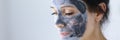 Woman`s face is covered with clay cosmetic mask for skin rejuvenation Royalty Free Stock Photo