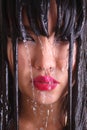 Woman's face with freckles under water jets