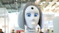 Woman`s face on a high-tech robot. Media. High-tech robot at the exhibition. Robotic of a human like droid robot Royalty Free Stock Photo