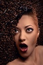 Woman's face over coffee beans Royalty Free Stock Photo