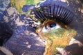 Woman`s face with planet Earth texture and serbian flag inside the eye. Royalty Free Stock Photo