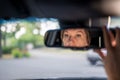 Woman`s face in the rear view mirror in her car. Woman driving Royalty Free Stock Photo