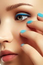 Woman`s face with vivid make-up and colorful nail polish Royalty Free Stock Photo