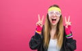 Woman in 1980`s fashion giving the peace sign