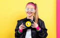 Woman in 1980`s fashion holding a record Royalty Free Stock Photo