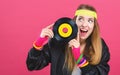 Woman in 1980`s fashion holding a record