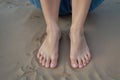A woman\'s feet with bare toes on sand. Royalty Free Stock Photo